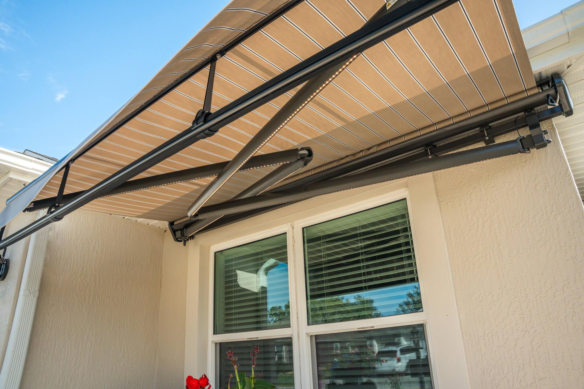 Retractable patio awning over window exterior