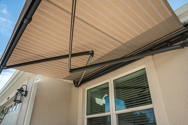 Retractable awning over house window and door