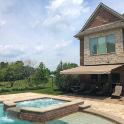 Luxury house with backyard pool and patio.