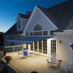 Cozy patio with awning at dusk.