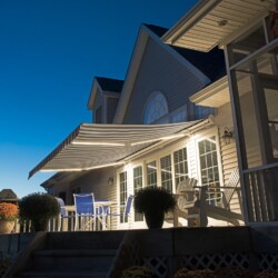 Patio with striped awning at night
