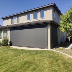 Modern house with grass lawn and trees.