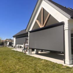 Outdoor roller shades on modern patio structure
