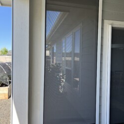 Outdoor retractable screen on a patio entryway.