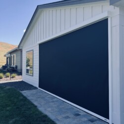 Modern house with large dark sliding panel.