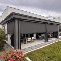 Modern patio with outdoor dining area and flowers.