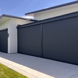 Modern house with large black garage doors.