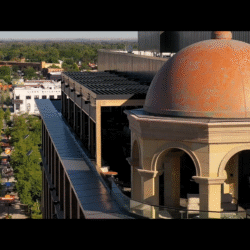 Historic dome building overlooking city street and landscape.